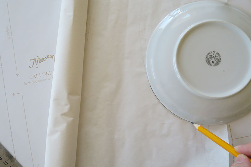 Use the curve of the plate to trace your lines