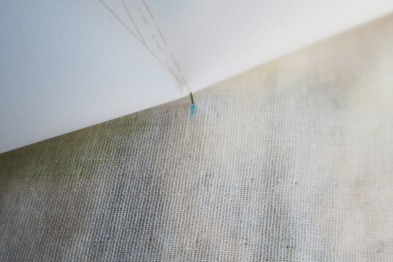 Lift the paper and mark the dart apex